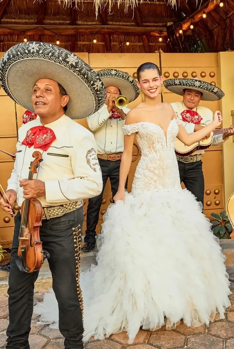 model is wearing an off the shoulder mermaid wedding dress