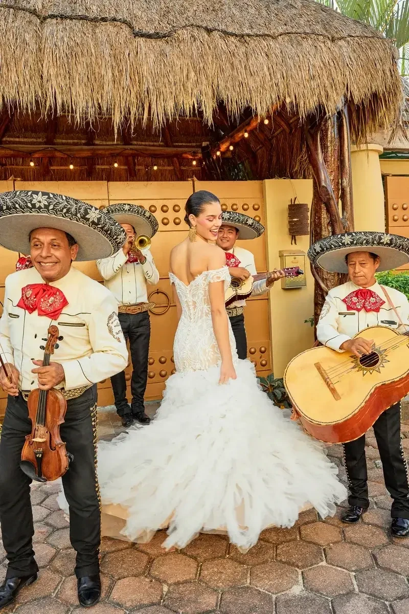 model is wearing an off the shoulder mermaid wedding dress